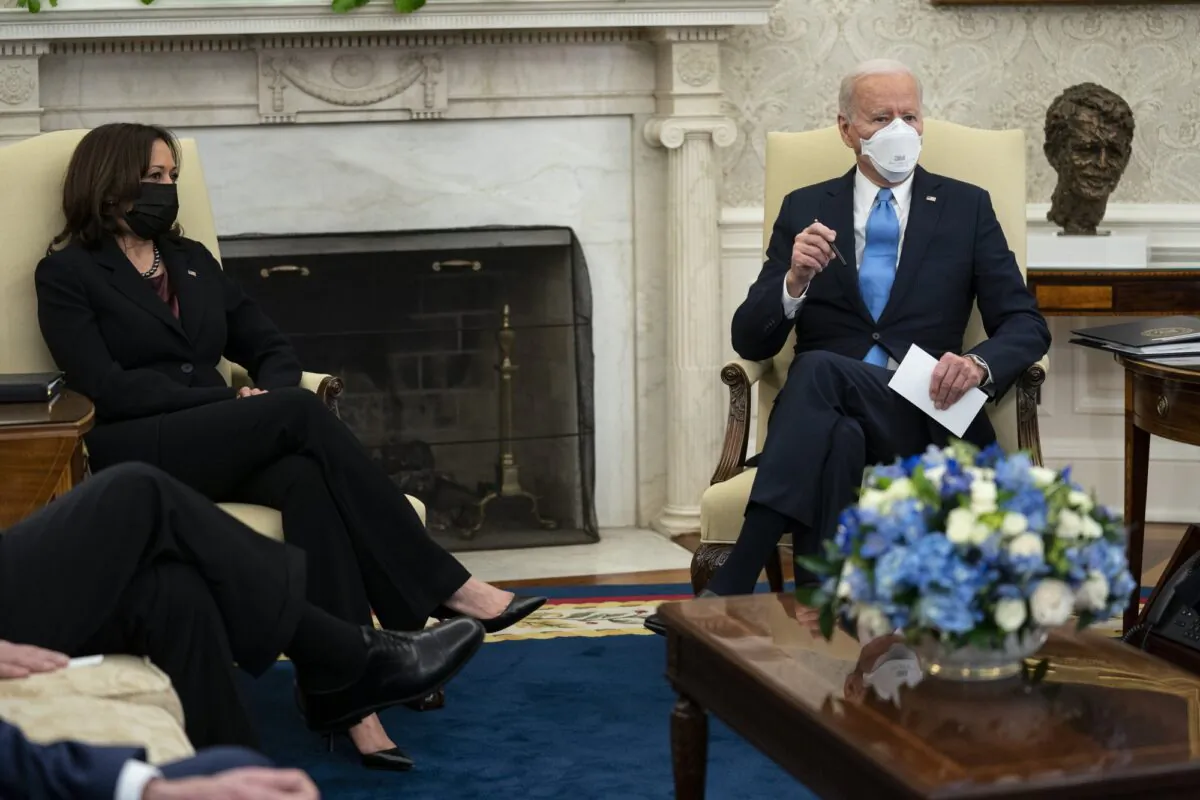 Vice President Kamala Harris listens as President Joe Biden speaks during a meeting with a bipartisan group of mayors and governors to discuss a COVID-19 relief package, in the Oval Office of the White House in Washington, on Feb. 12, 2021. (Evan Vucci/AP Photo)