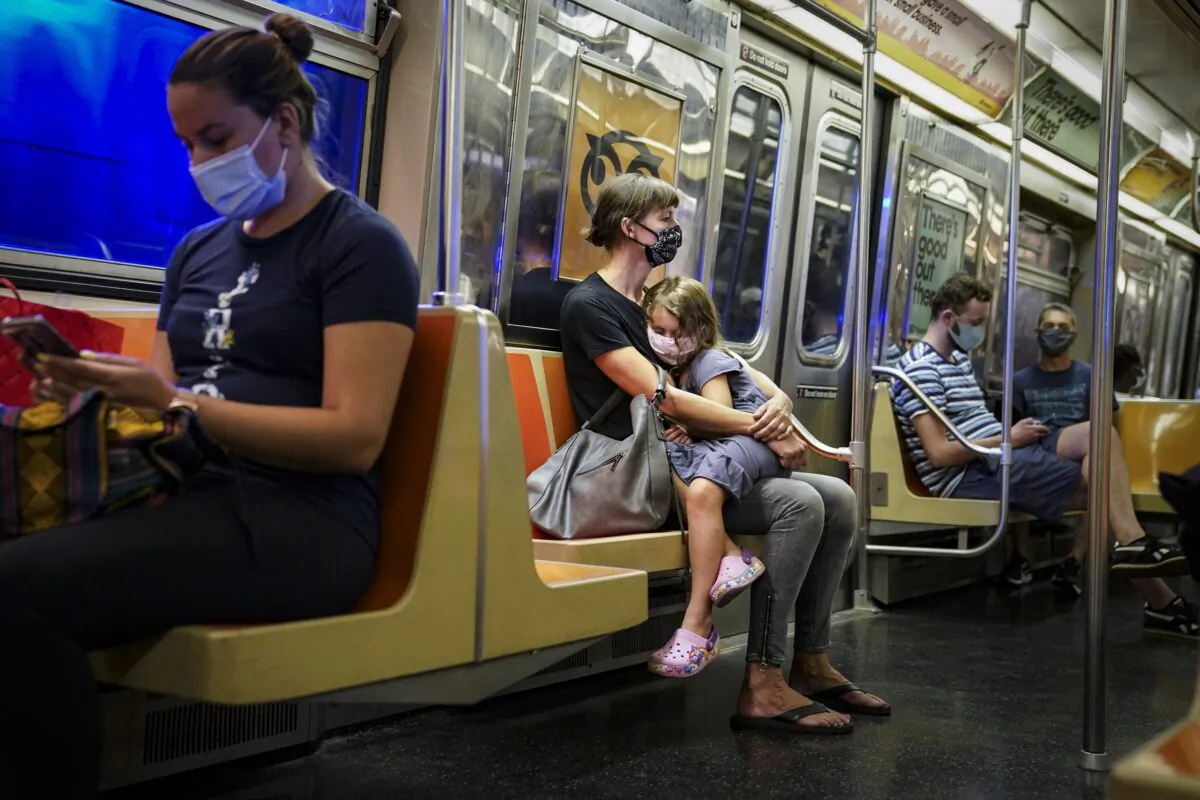 Riders on a subway train wearing protective masks due to COVID-19 concerns in New York on Aug. 17, 2020. (John Minchillo/AP Photo)