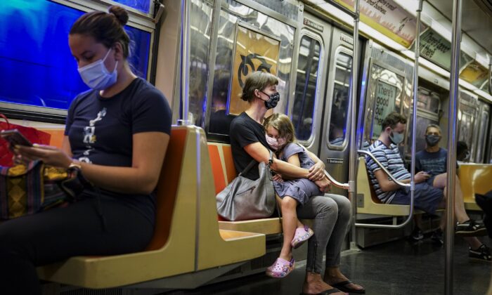 Riders on a subway train wearing protective masks due to COVID-19 concerns in New York on Aug. 17, 2020. (John Minchillo/AP Photo)