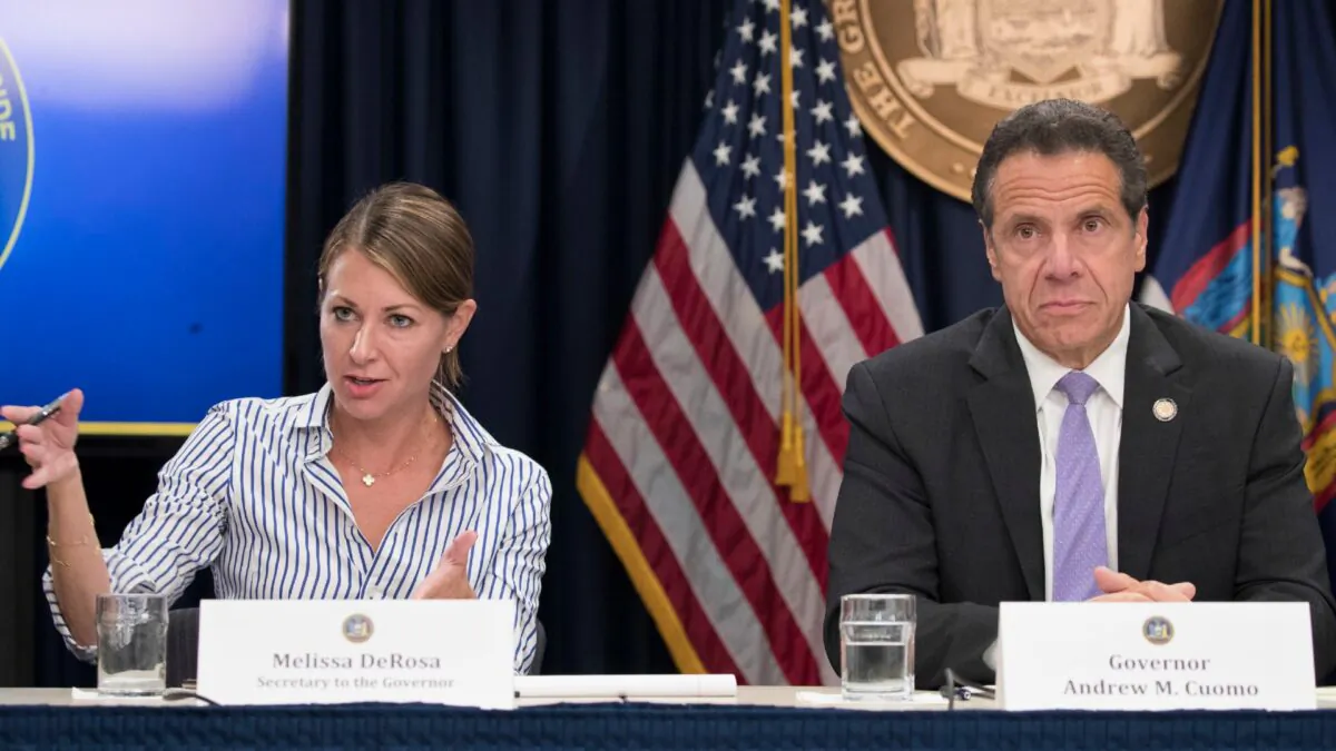 Secretary to the Governor Melissa DeRosa, is joined by New York Gov. Andrew Cuomo as she speaks to reporters during a news conference, in New York, on Sept. 14, 2018. (Mary Altaffer/File, AP)