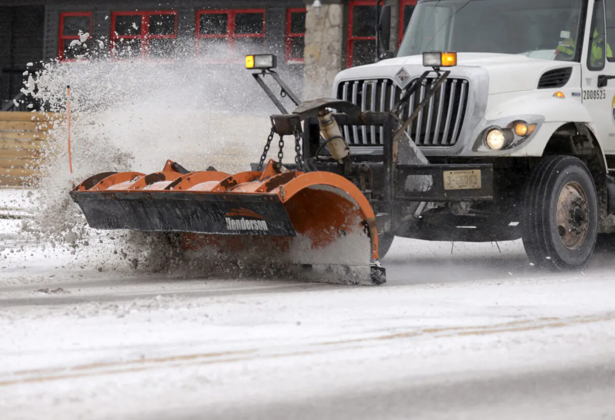 A City of Tulsa snow plow clears Harvard Ave. near 16th street in Tulsa, Okla., on Feb. 14, 2021. (John Clanton/Tulsa World via AP)