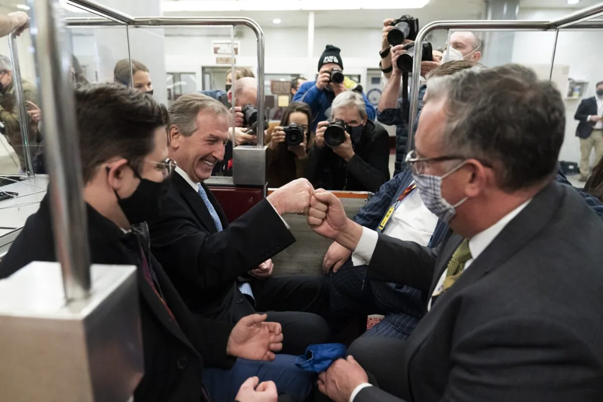 Former President Donald Trump lawyer Michael van der Veen (2nd L) celebrates with colleagues after the acquittal of Trump, on the Senate subway in Washington on Feb. 13, 2021. (Alex Brandon/AP Photo)
