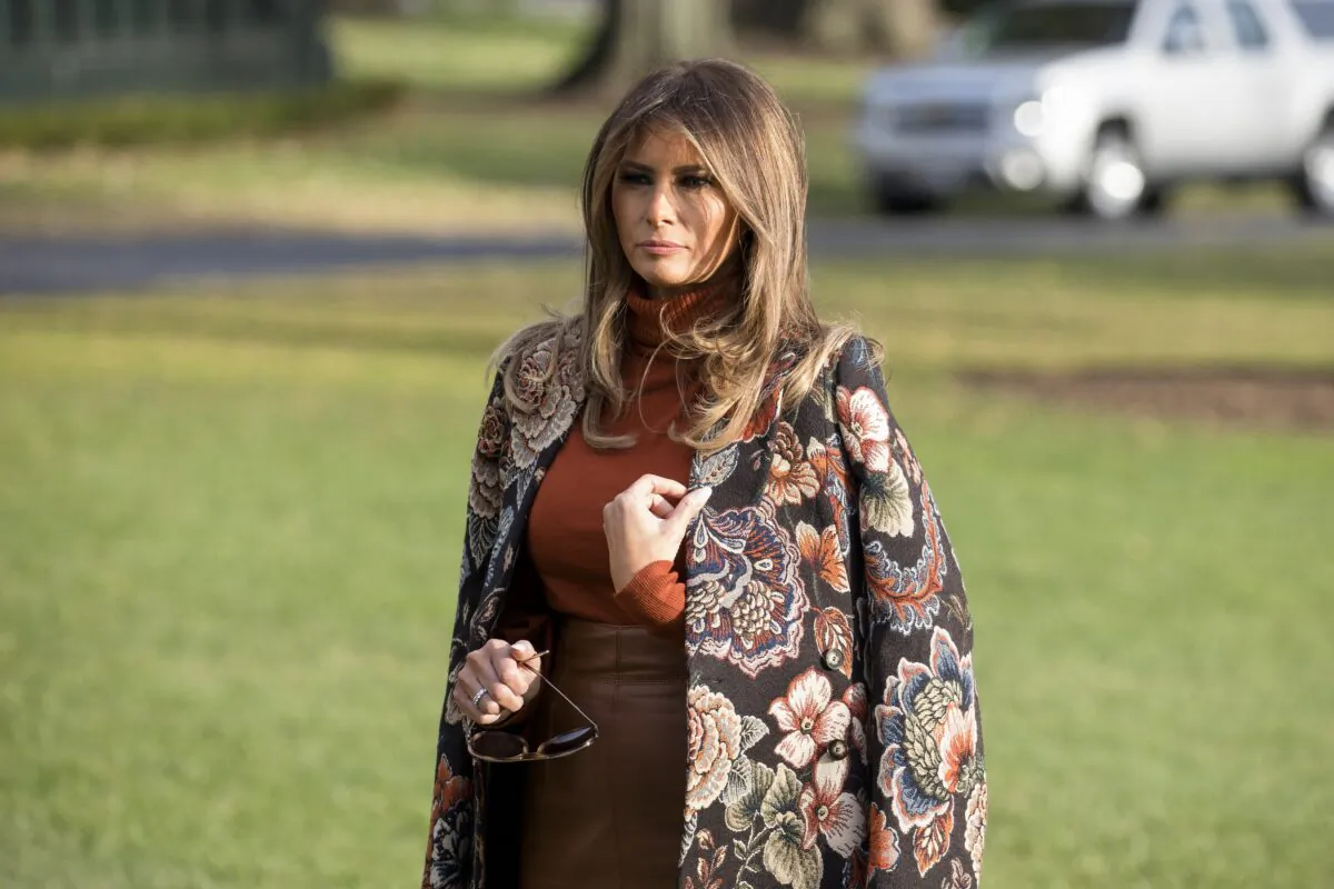 First Lady Melania Trump waits as President Donald Trump talks to reporters before departing with his family from the White House to his Mar-a-Lago resort in Florida for the Thanksgiving holiday, in Washington on Nov. 21, 2017. (Samira Bouaou/The Epoch Times)