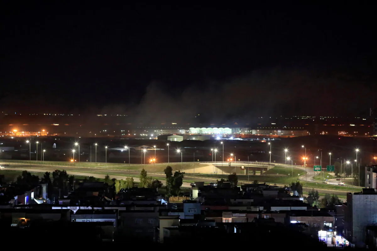 Smoke rises over the Erbil, after reports of mortar shells landing near Erbil airport, Iraq Feb. 15, 2021. (REUTERS/Thaier al-Sudani)