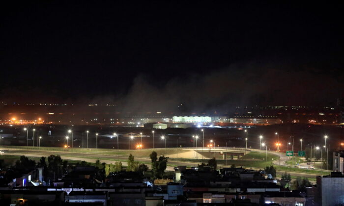 Smoke rises over the Erbil, after reports of mortar shells landing near Erbil airport, Iraq Feb. 15, 2021. (REUTERS/Thaier al-Sudani)