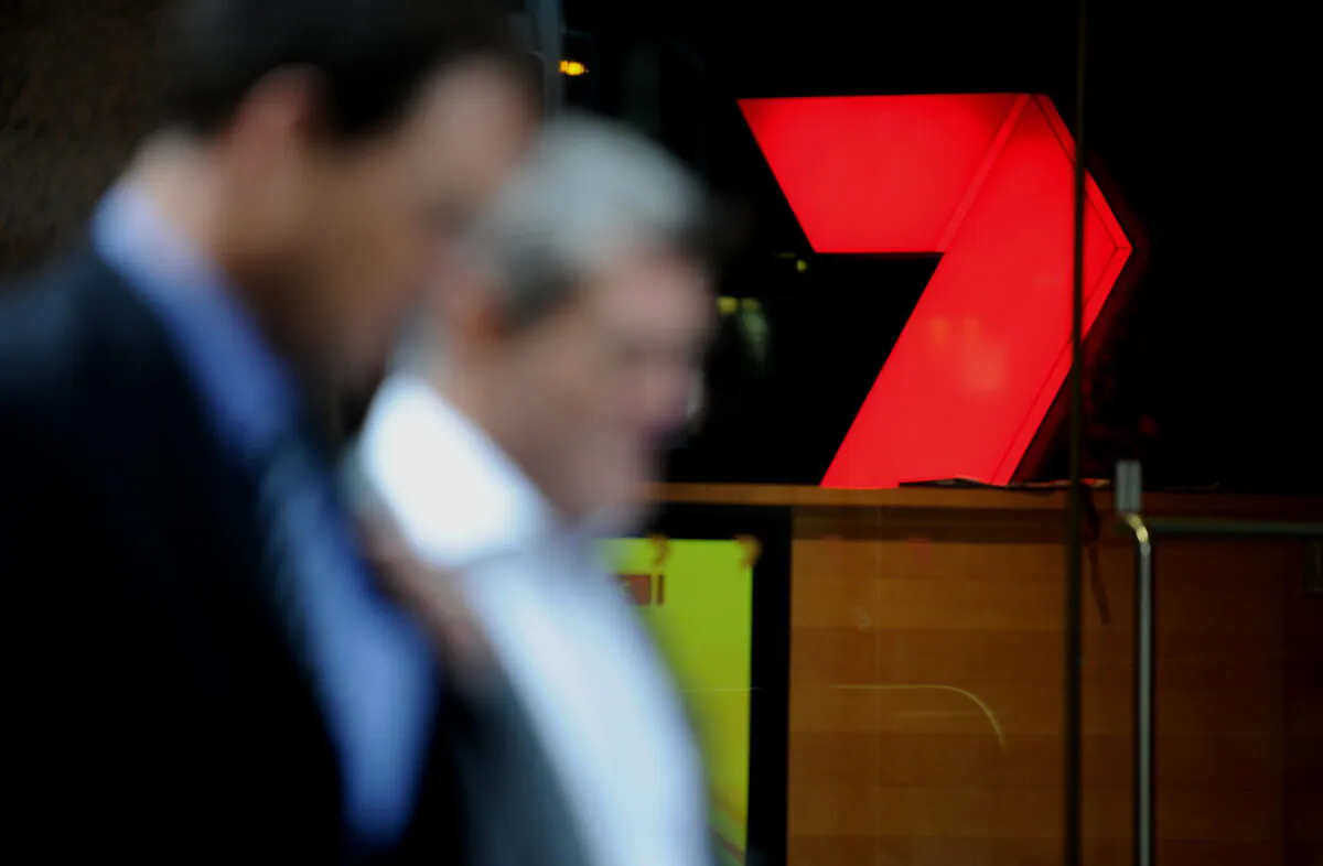 Pedestrians walk past signage of the Seven Television Network in central Sydney on Feb. 21, 2011. (Greg Wood/AFP via Getty Images)
