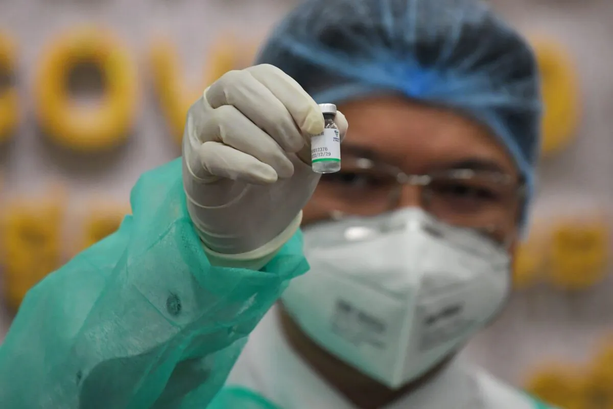 A medical worker shows the Sinopharm vaccine from China during the first day vaccination against the COVID-19 at Calmette hospital in Phnom Penh, Cambodia, on Feb. 10, 2021. (TANG CHHIN SOTHY/AFP via Getty Images)