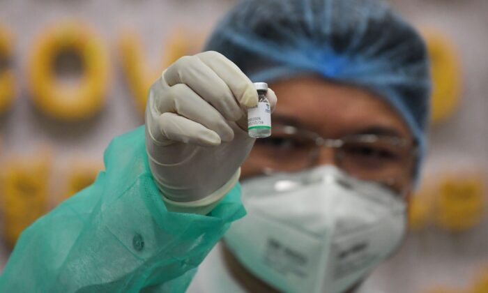 A medical staff shows the Sinopharm vaccine from China during the first day vaccination against the COVID-19 at Calmette hospital in Phnom Penh, Cambodia on Feb. 10, 2021. (TANG CHHIN SOTHY/AFP via Getty Images)