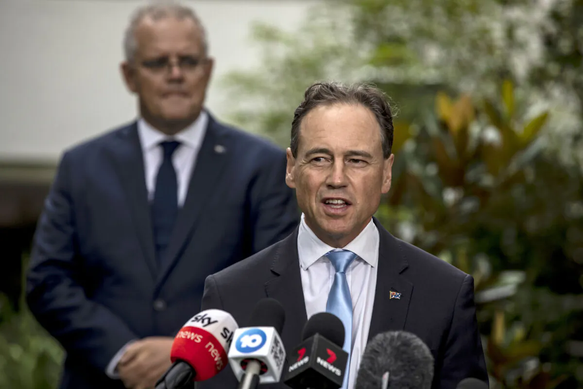 Health Minister Greg Hunt speaks as Prime Minister Scott Morrison looks on at the news conference at the CSL facility in Melbourne, Australia, on Feb. 12, 2021. (Diego Fedele/Getty Images)