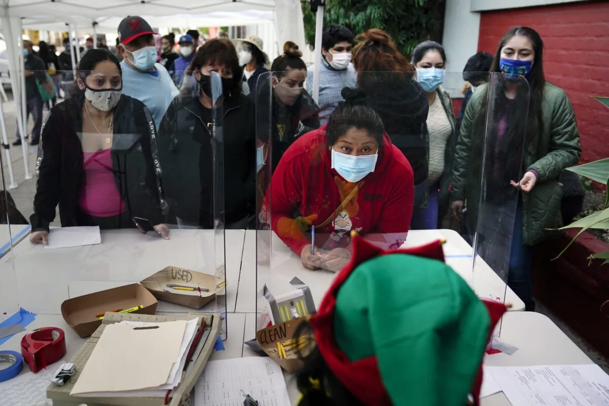 People check in at a food bank held at Los Angeles Boys & Girls Club in the Lincoln Heights neighborhood of Los Angeles, Calif., on Dec. 17, 2020. (Jae C. Hong/AP Photo)