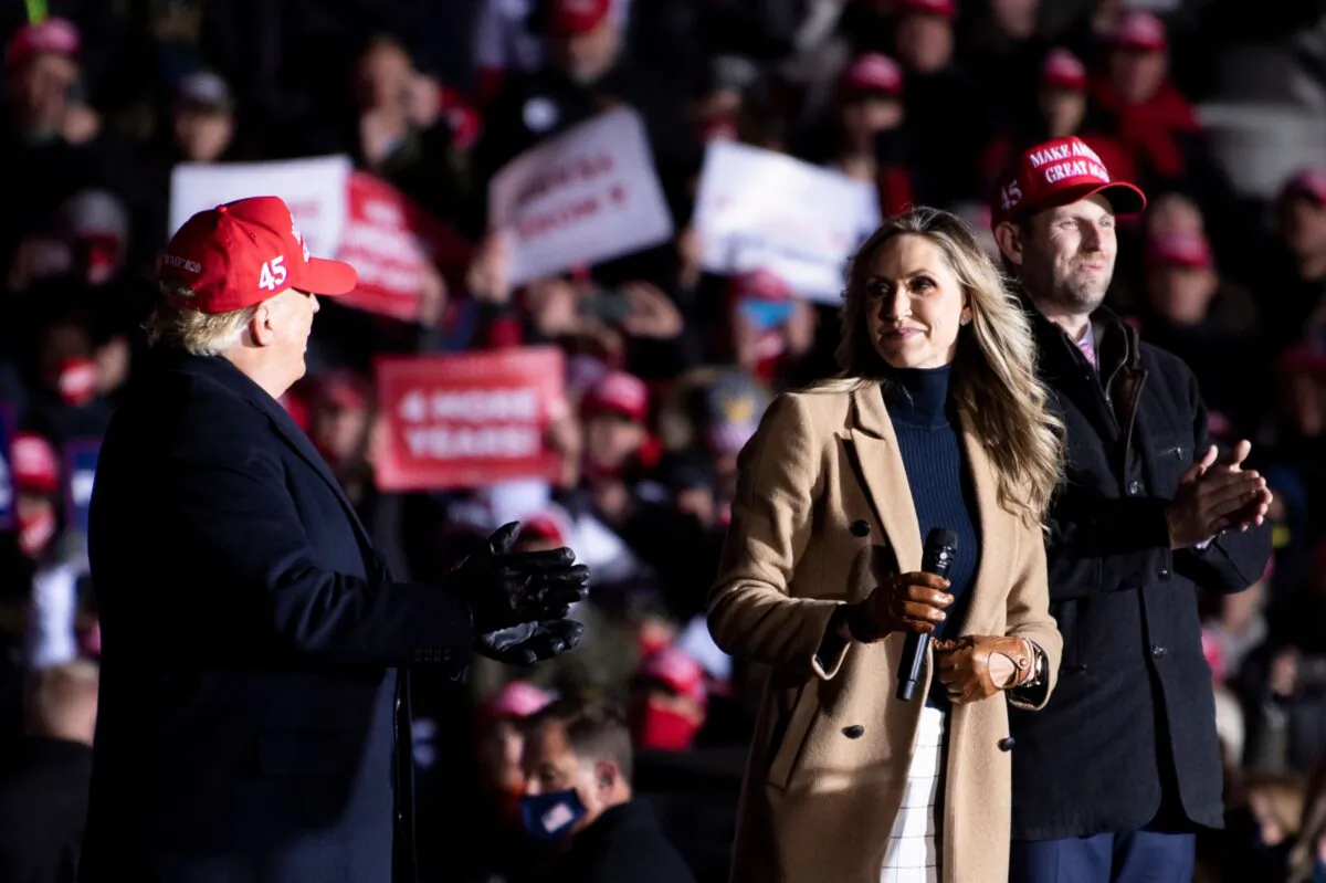 President Donald Trump and his son Eric listen while campaign adviser Lara Trump speaks during a Make America Great Again rally at Kenosha Regional Airport in in Kenosha, Wis., on Nov. 2, 2020, (Brendan Smialowski/AFP via Getty Images)