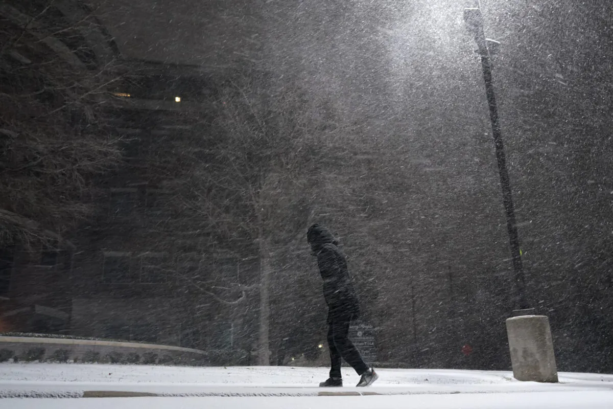 A woman walks through falling snow in San Antonio on Feb. 14, 2021. (Eric Gay/AP Photo)
