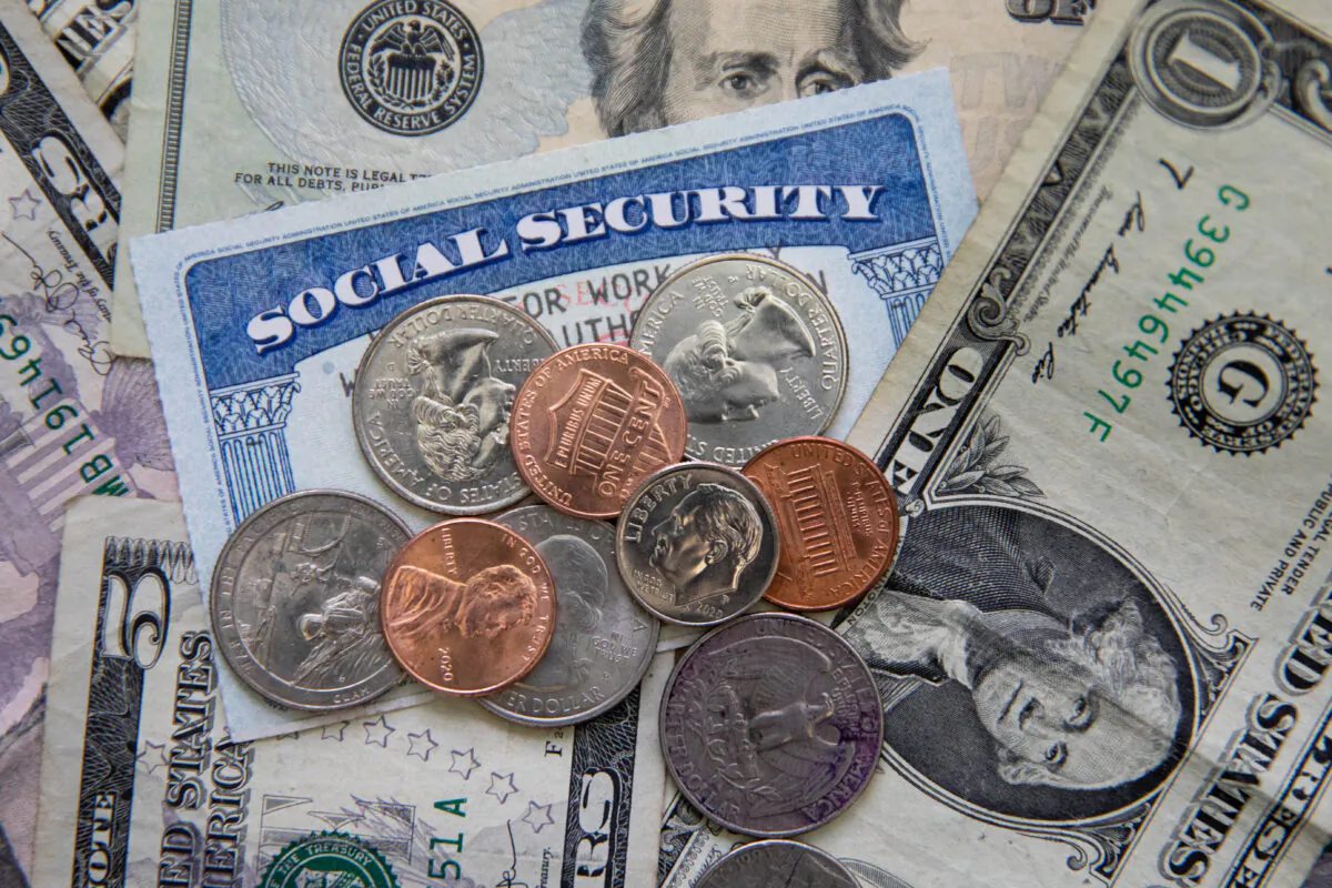 A social security card with coins and cash in New York on Feb. 14, 2021. (Chung I Ho/The Epoch Times)