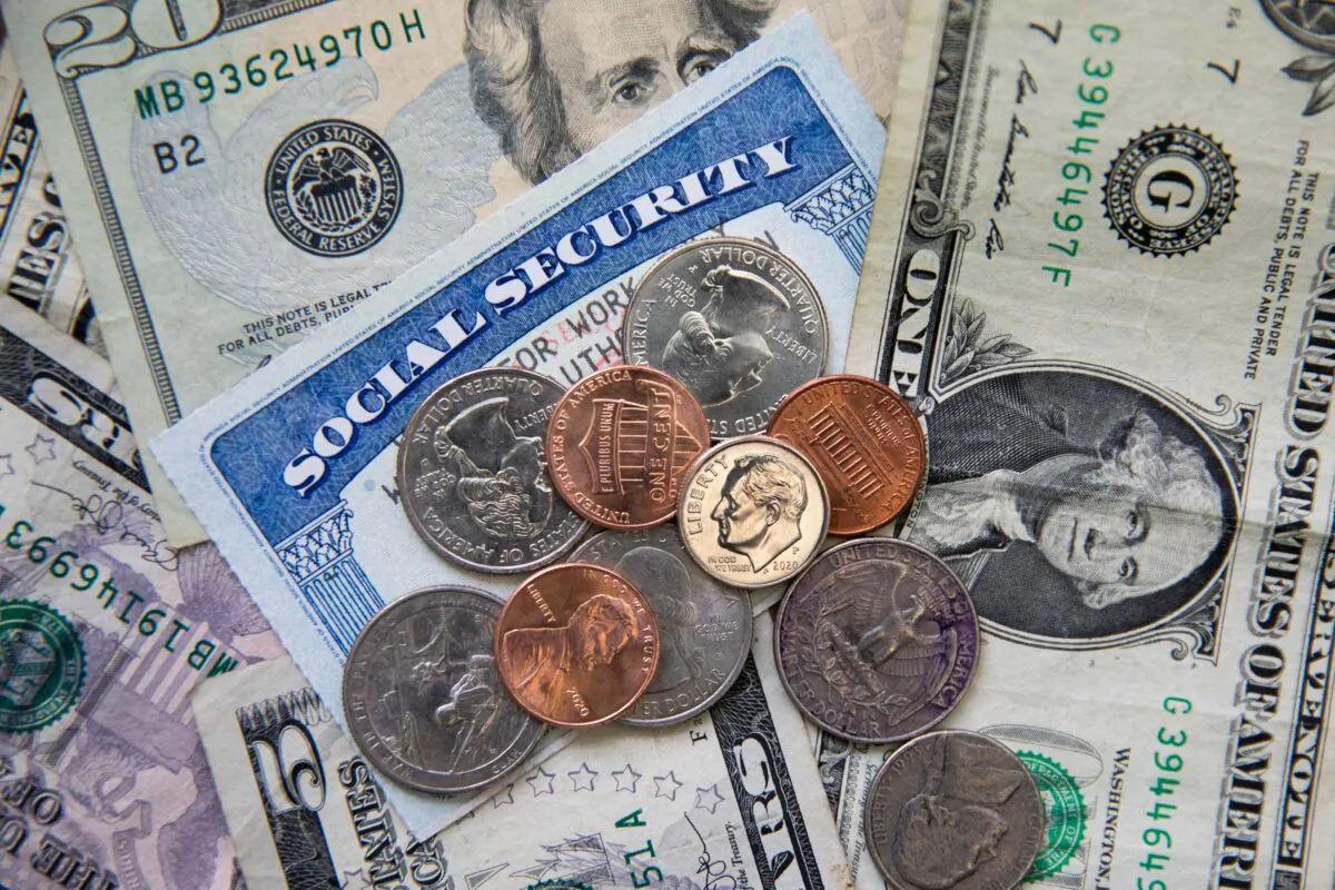 A Social Security card with coins and cash in New York on Feb. 14, 2021. (Chung I Ho/The Epoch Times)