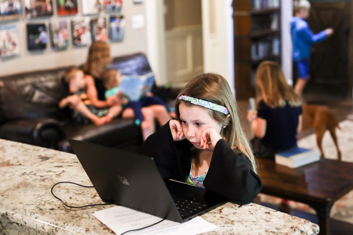 A girl does her schoolwork at home in Bethesda, Md., on July 11, 2020. (Charlotte Cuthbertson/The Epoch Times)