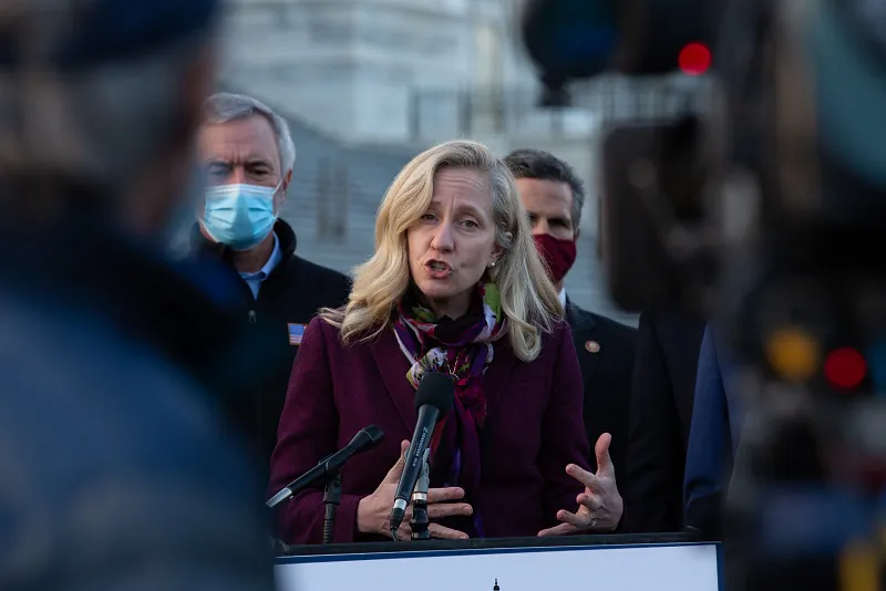Rep. Abigail Spanberger (D-Va.) speaks at the podium standing with members of the Problem Solvers Caucus in a press conference outside the U.S. Capitol on Dec. 21, 2020. (Cheriss May/Getty Images)