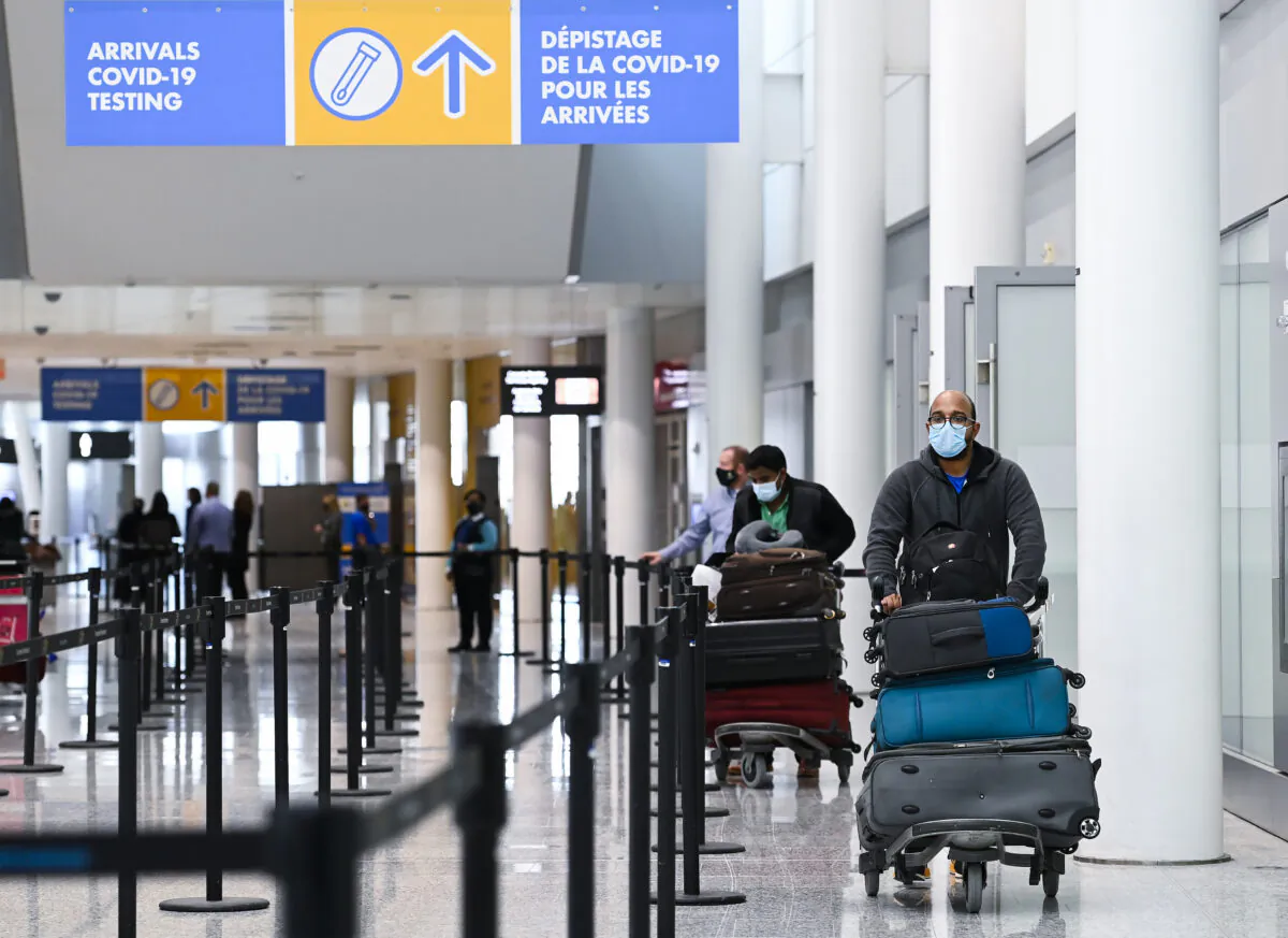 Travellers arrive at the Toronto Pearson International Airport in Toronto on Feb. 1, 2021. (THE CANADIAN PRESS/Nathan Denette)