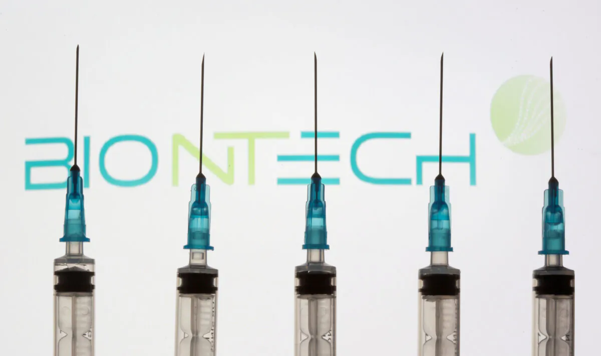 Syringes in front of a displayed BioNtech logo in this illustration taken Nov. 10, 2020. (Dado Ruvic/Reuters)