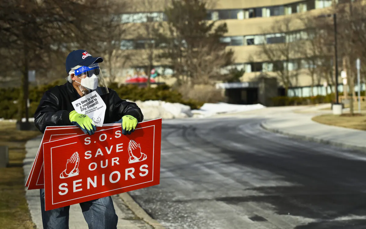 A man protests outside the Tendercare Living Centre long-term-care facility during the COVID-19 pandemic in Scarborough, Ont., on Dec. 29, 2020. (The Canadian Press/Nathan Denette)