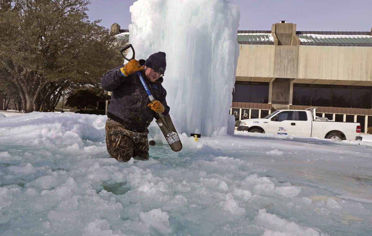 breaks ice on a frozen fountain