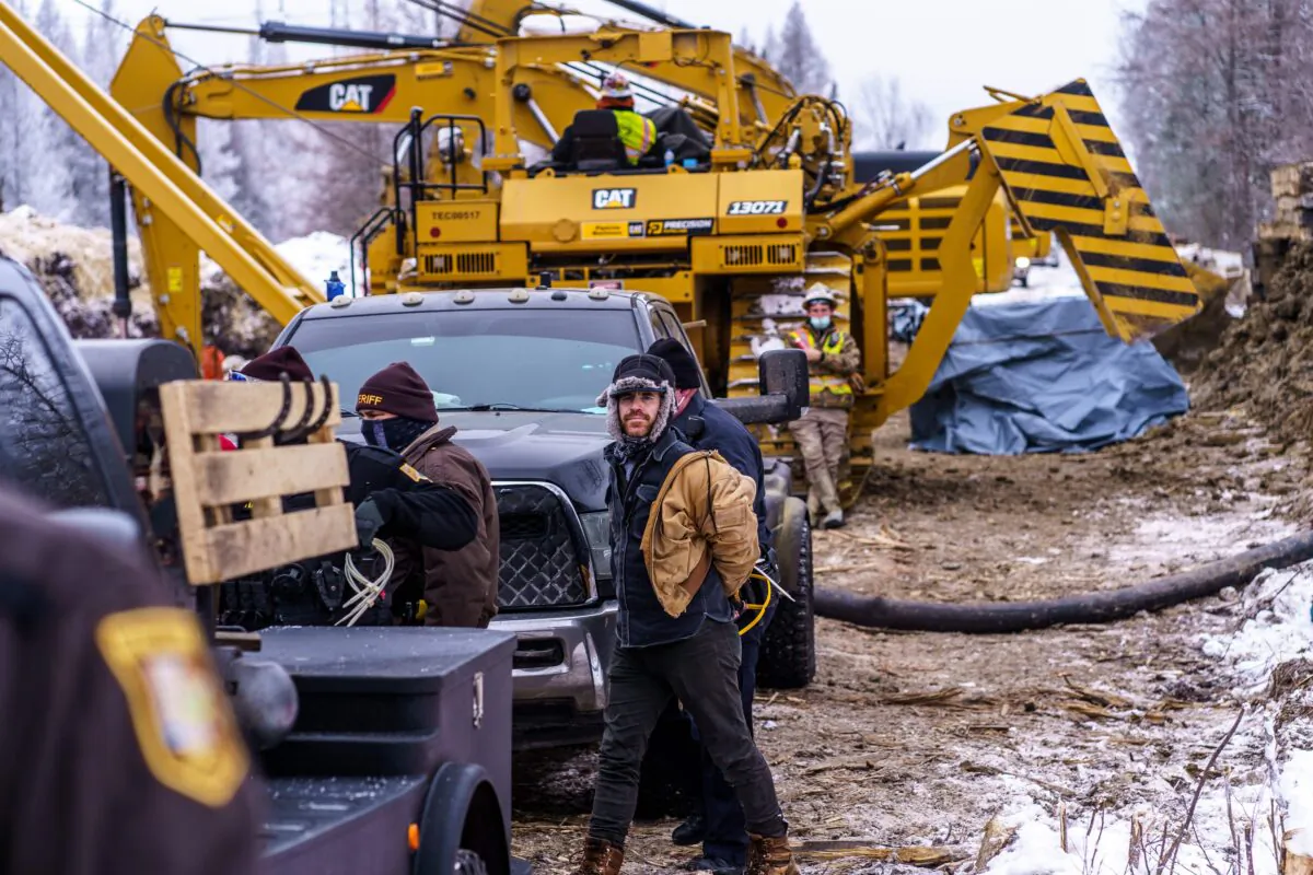 Aitkin County sheriffs arrest "water protectors" during a protest at the construction site of the Line 3 oil pipeline near Palisade, Minn., on Jan. 9, 2021. (Kerem Yucel/AFP via Getty Images)
