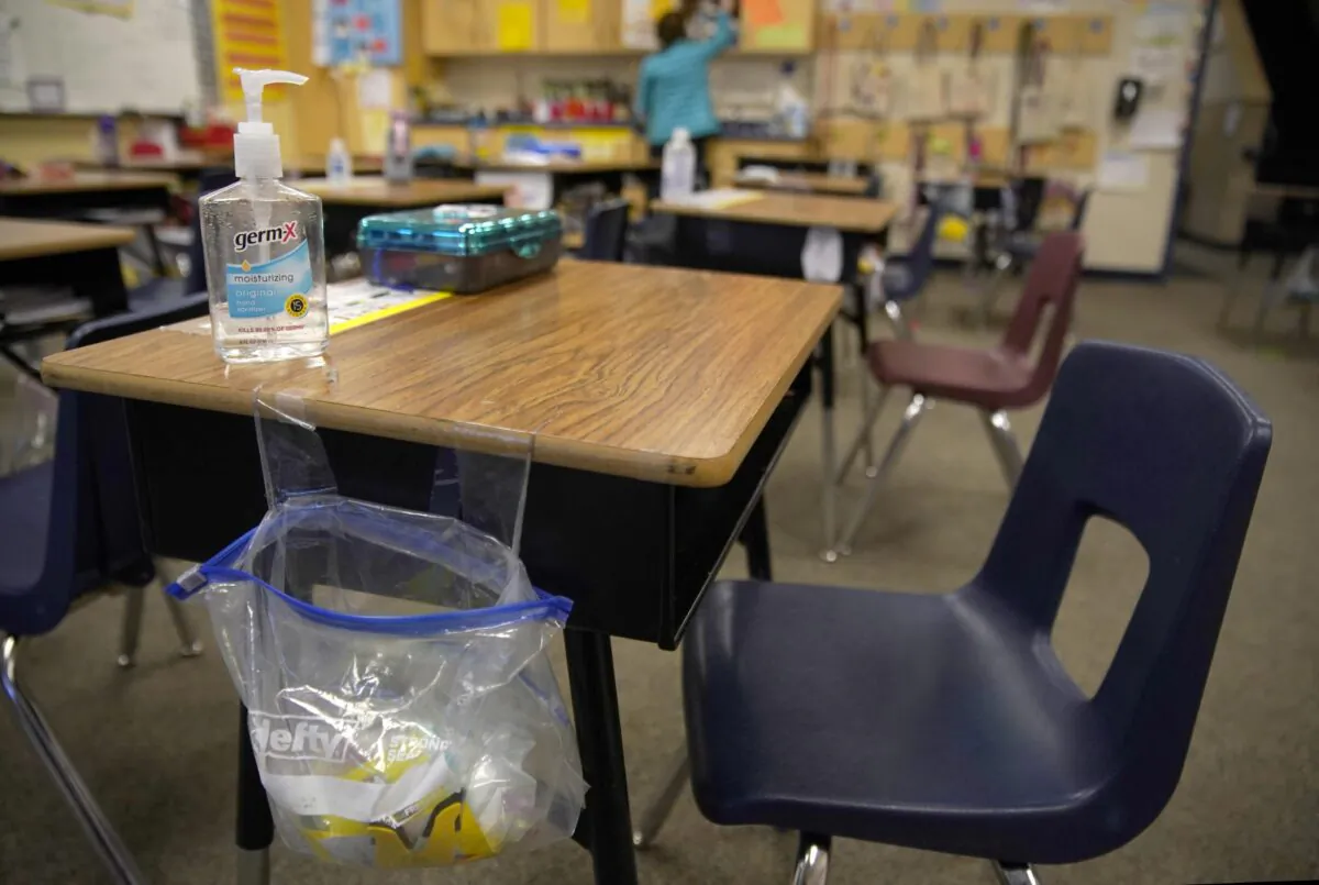 A teacher prepares her classroom before students arrive for school at Freedom Preparatory Academy in Provo, Utah, on Feb. 10, 2021. (George Frey/Getty Images)
