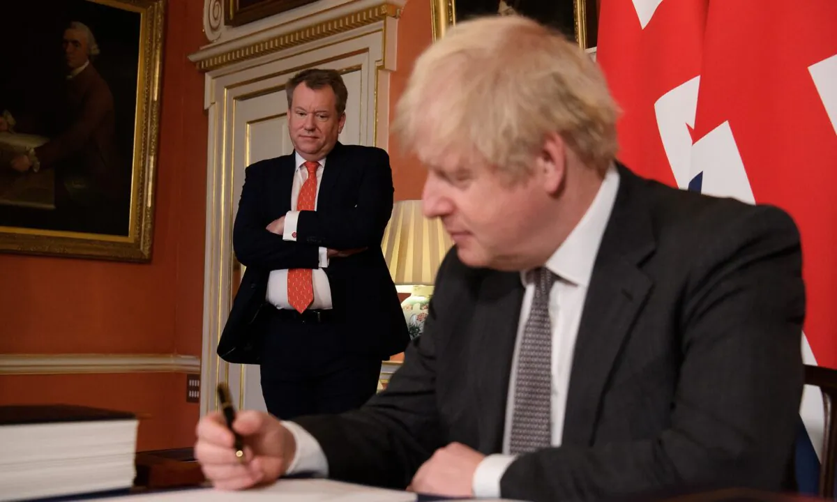 UK chief negotiator David Frost looks on as Britain's Prime Minister Boris Johnson poses for a picture after signing the Brexit trade deal with the EU at number 10 Downing Street in London, Britain, on Dec. 30, 2020. (Leon Neal/Pool via Reuters)