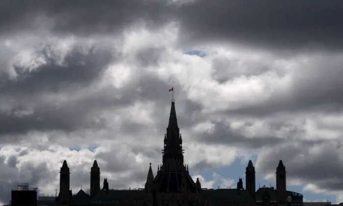 Clouds pass by the parliament buildings in Ottawa on Aug. 19, 2020. (Adrian Wyld/The Canadian Press)