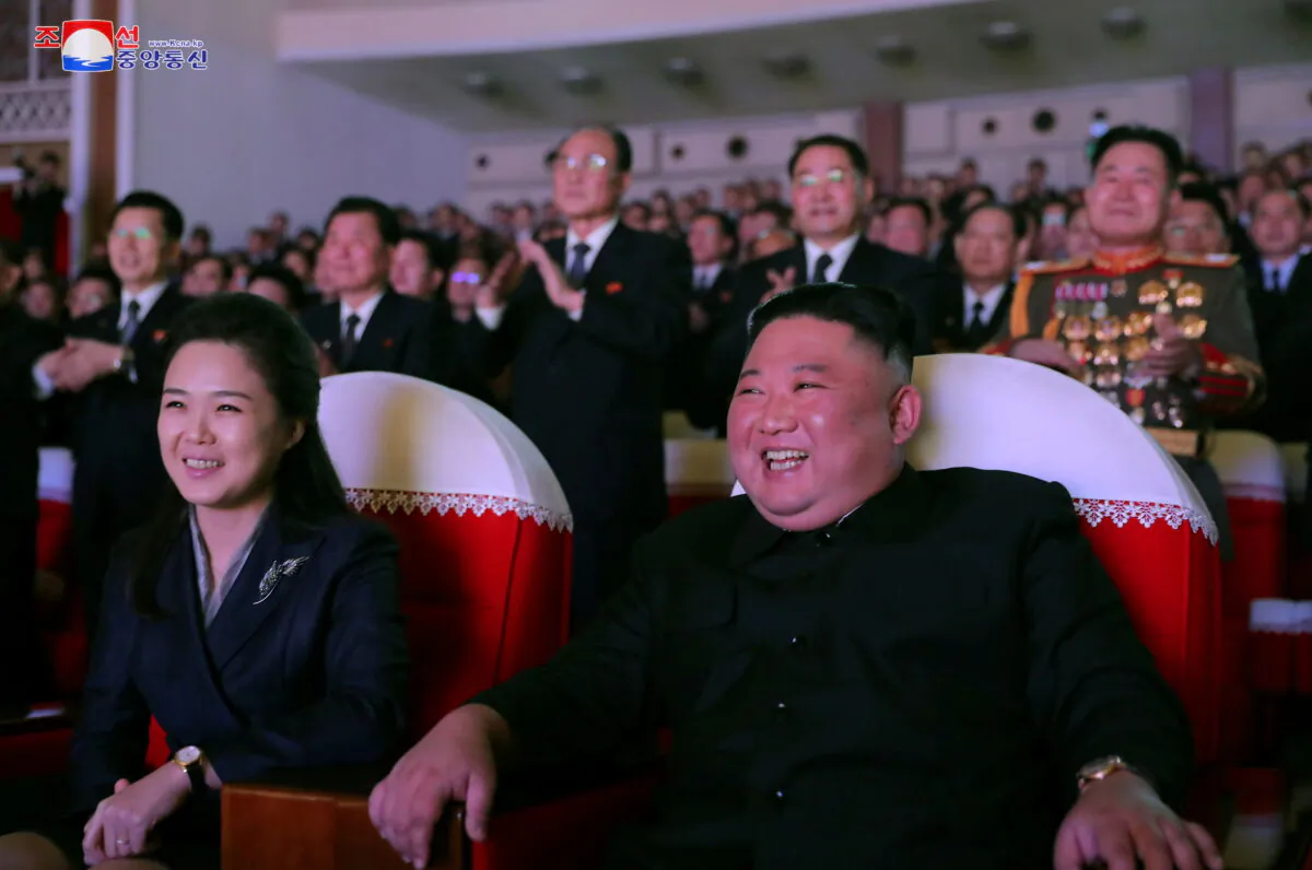 North Korean leader Kim Jong Un and his wife Ri Sol Ju watch a performance that commemorated the Day of the Shining Star, the birth anniversary of the late leader Kim Jong Il at the Mansudae Art Theatre in Pyongyang, North Korea in this undated photo released by North Korea's Korean Central News Agency (KCNA) on Feb. 17, 2021. (KCNA via Reuters)