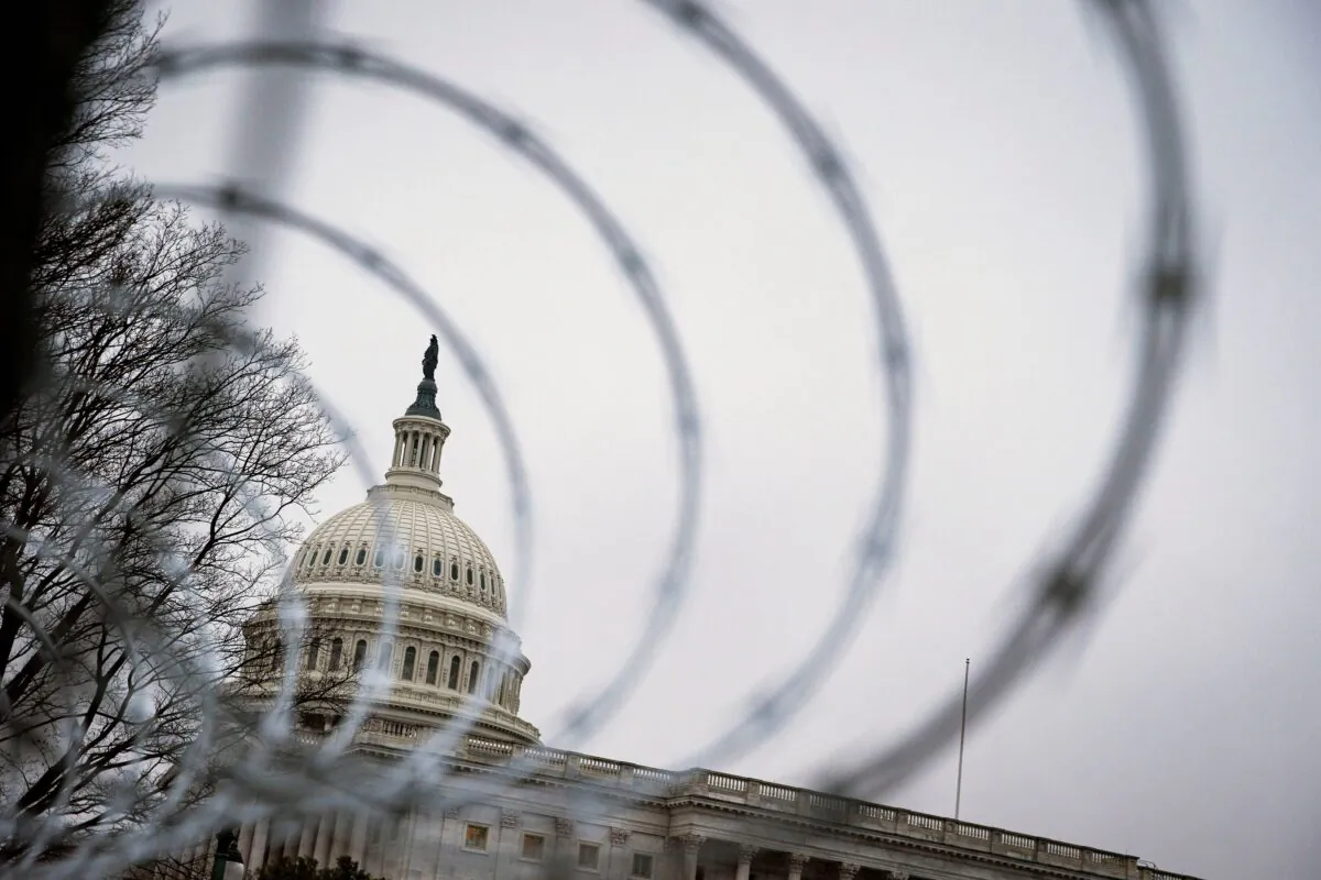 Barbed wire and security fencing surrounds the U.S. Capitol in Washington on Jan. 26, 2021. (Al Drago/Reuters)
