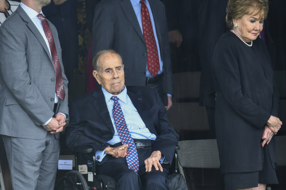 Former U.S. Sen. Bob Dole and his wife Elizabeth Dole wait as President Donald Trump arrives to participate in the Armed Forces Welcome Ceremony in honor of the Twentieth Chairman of the Joint Chiefs of Staff at Summerall Field, Joint Base Myer-Henderson Hall, Va., on Sept. 30, 2019. (Brendan Smialowski/AFP via Getty Images)