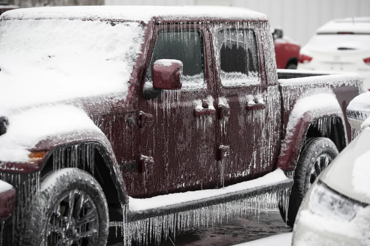 Thick ice accumulating on a parked car as the area continues to deal with the fall out from winter weather in Huntington, W.Va., on Feb. 17, 2021. (Sholten Singer/The Herald/Dispatch via AP)