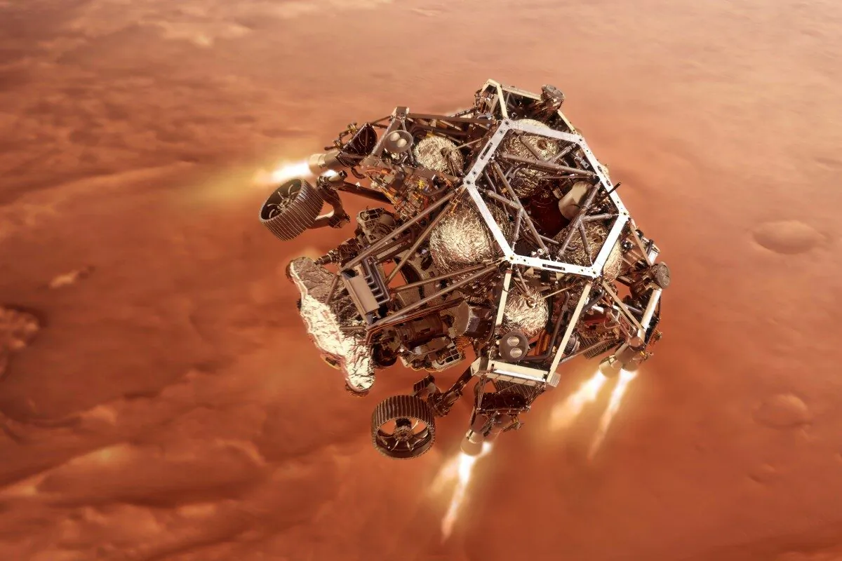 In this illustration provided by NASA, the Perseverance rover fires up its descent stage engines as it nears the Martian surface. This phase of its entry, descent and landing sequence, or EDL, is known as "powered descent." (NASA/JPL-Caltech via AP)