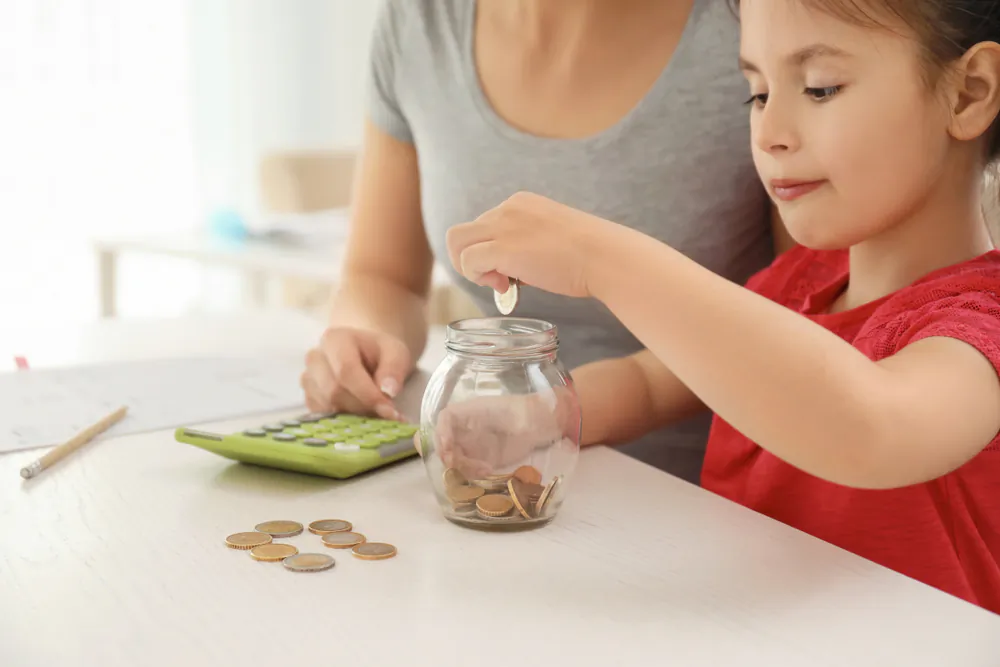 Use a four-jar money management system to help your children use their math skills while developing a habit of managing their money before they spend it. (Pixel-Shot/Shutterstock)