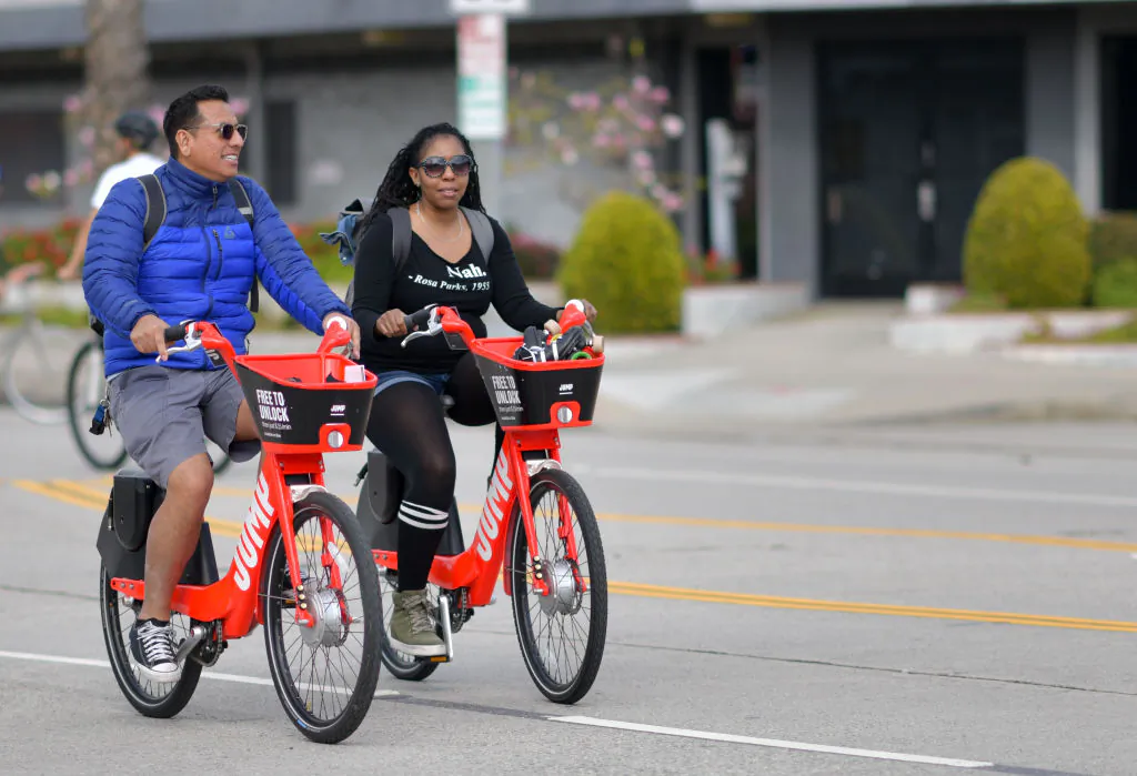 People ride Uber's JUMP e-bikes in car-free streets during a CicLAvia event in Culver City on March 3, 2019.  CicLAvia is a non-profit organization that hosts events where people can bike, walk, skate and stroll on car-free streets. (Chris Delmas/AFP via Getty Images)