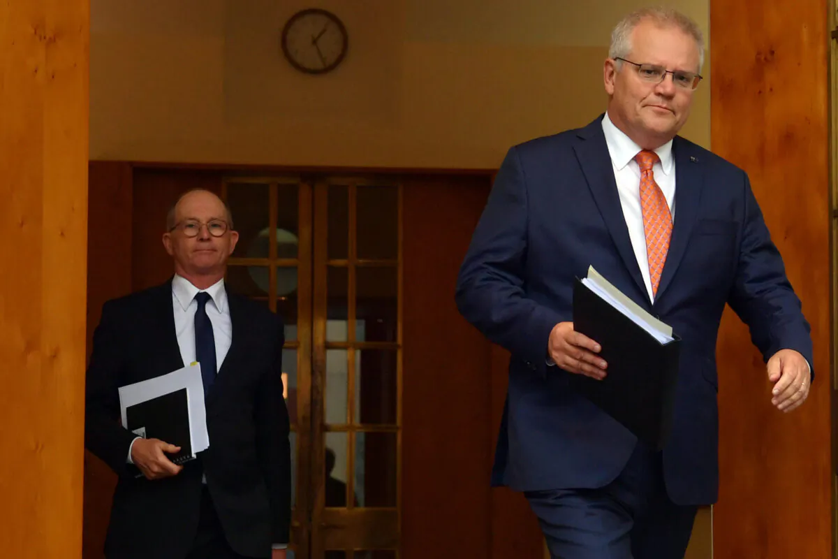 CANBERRA, AUSTRALIA - FEBRUARY 05: Prime Minister Scott Morrison (right) arrives with Chief Medical Officer Paul Kelly (left) during a press conference in the Prime Minister's Courtyard on February 05, 2021 in Canberra, Australia. Prime Minister Morrison and national cabinet met this morning to discuss Economy and COVID-19 hotel quarantine arrangements. Victoria has reported no new Covid-19 cases as South Austraila Premier Steven Marshall confirmed that the hard border arrangement with WA is being removed immediately. (Photo by Sam Mooy/Getty Images)