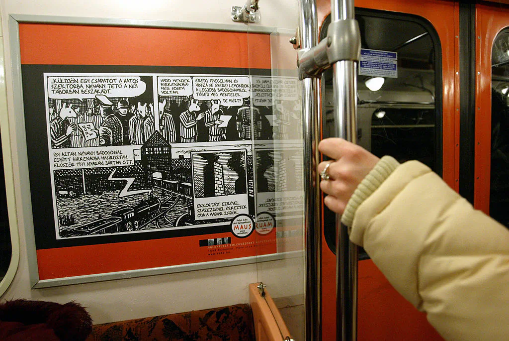 Part of a serial shows up on the wall of a Budapest metro train March 4, 2005 as an exhibition opened today in the Budapest  underground about the work of an artist who has translated the horror of the Holocaust into a comic book novel. Pictures from Art Spiegelman's "Maus," in which the New York-based artist draws Jews as mice and Germans as cats in a black-and-white interpretation of his own parents' survival of the Auschwitz death camp, have gone on view on two metro lines. (Attila Kisbenedek/AFP via Getty Images)