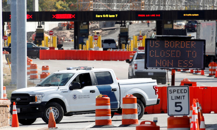 A U.S. Customs and Protection vehicle stands beside a sign reading that the border is closed to non-essential traffic at the Canada-United States border crossing at the Thousand Islands Bridge, to combat the spread of COVID-19 in Lansdowne, Ontario, Canada on Sept. 28, 2020. (Lars Hagberg/Reuters)