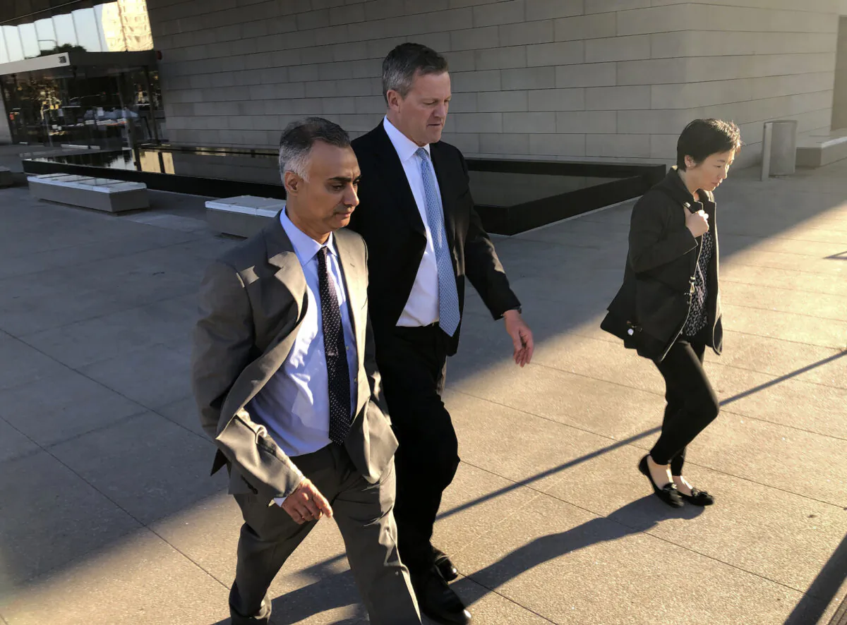 Imaad Zuberi, left, leaves the federal courthouse with his attorney Thomas O’Brien, second from left, in Los Angeles on Friday, Nov. 22, 2019. Zuberi pleaded guilty to funneling donations from foreigners to U.S. political campaigns.  (Brian Melley/AP Photo)