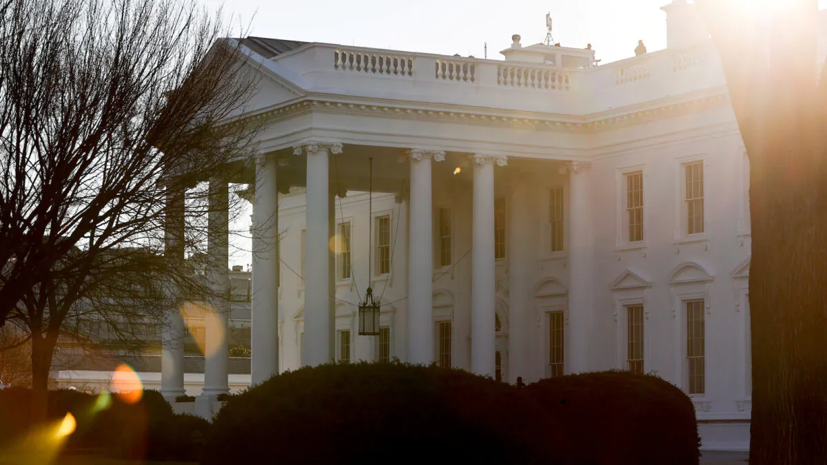 A general view of the sun rising behind the White House in Washington, on Jan. 22, 2021. (Jonathan Ernst/Reuters)