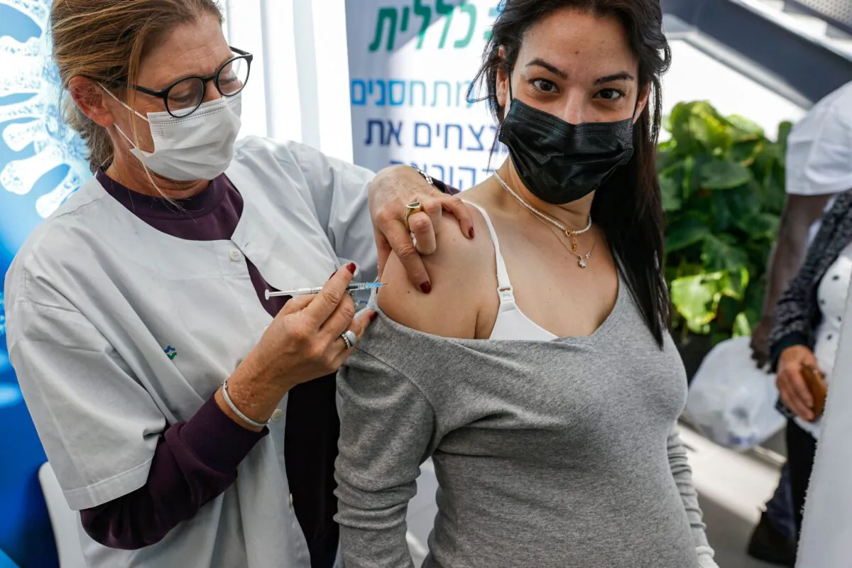 A health worker administers a dose of the Pfizer-BioNtech COVID-19 vaccine to a pregnant woman at Clalit Health Services, in Israel's Mediterranean coastal city of Tel Aviv on Jan. 23, 2021. (Jack Guez/AFP via Getty Images)