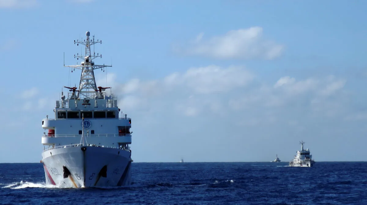 Chinese coastguard ships give chase to Vietnamese coastguard vessels (not pictured) after they came within 10 nautical miles of the Haiyang Shiyou 981, known in Vietnam as HD-981, oil rig in the South China Sea, on July 15, 2014. (Martin Petty/Reuters)