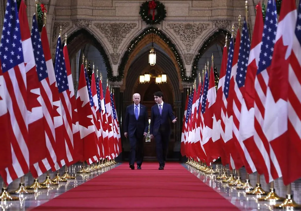 Prime Minister Justin Trudeau and then-U.S. Vice-President Joe Biden walk down the Hall of Honour on Parliament Hill in Ottawa on Dec. 9, 2016. (Patrick Doyle/The Canadian Press)