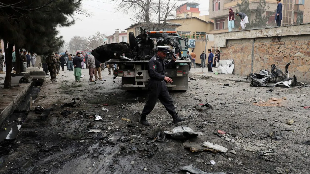 Security personnel inspect the site of a bomb attack in Kabul, Afghanistan, Saturday, Feb. 20, 2021. (Rahmat Gul/AP)