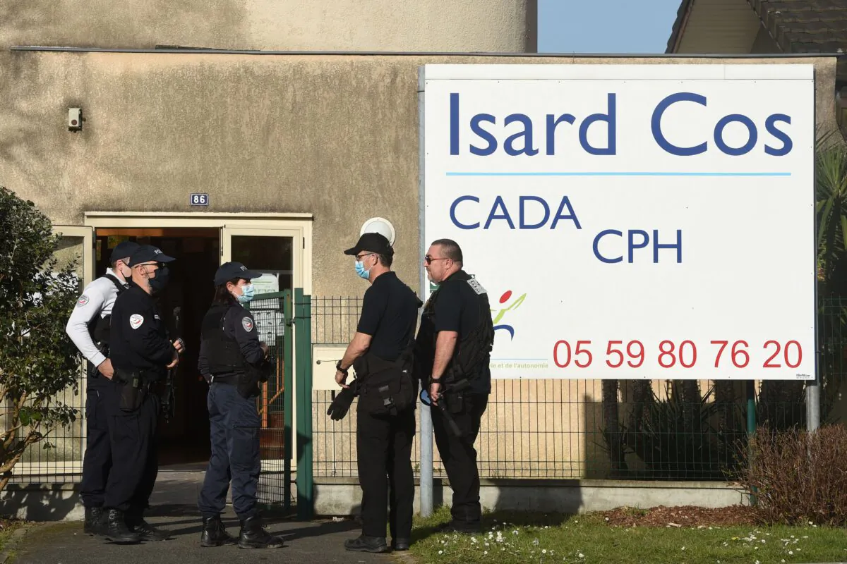 Police officers stand at the entrance of the Isard COS Reception Center for Asylum Seekers (CADA) in Pau, where a manager has been stabbed to death by an asylum seeker in Pau, southwestern france, on Feb. 19, 2021. The victim, a 46-year-old father, was stabbed to death by a Sudanese man whose asylum application had just been refused, according to French police. (Gaizka Iroz/AFP via Getty Images)
