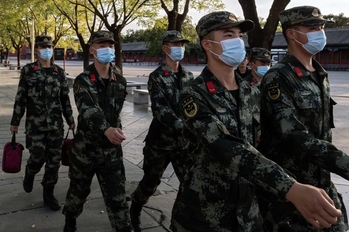Paramilitary police officers march in front of the entrance to the Forbidden City (not pictured) in Beijing on Sept. 20, 2020. (Nicolas Asfouri/AFP via Getty Images)