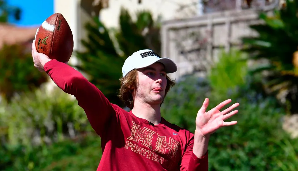 High school football quarterback Gunnar Hensley throws to his dad Brad on neighborhood streets near their home in Carlsbad, Calif., on Feb. 18, 2021.(Frederic J. Brown/AFP)