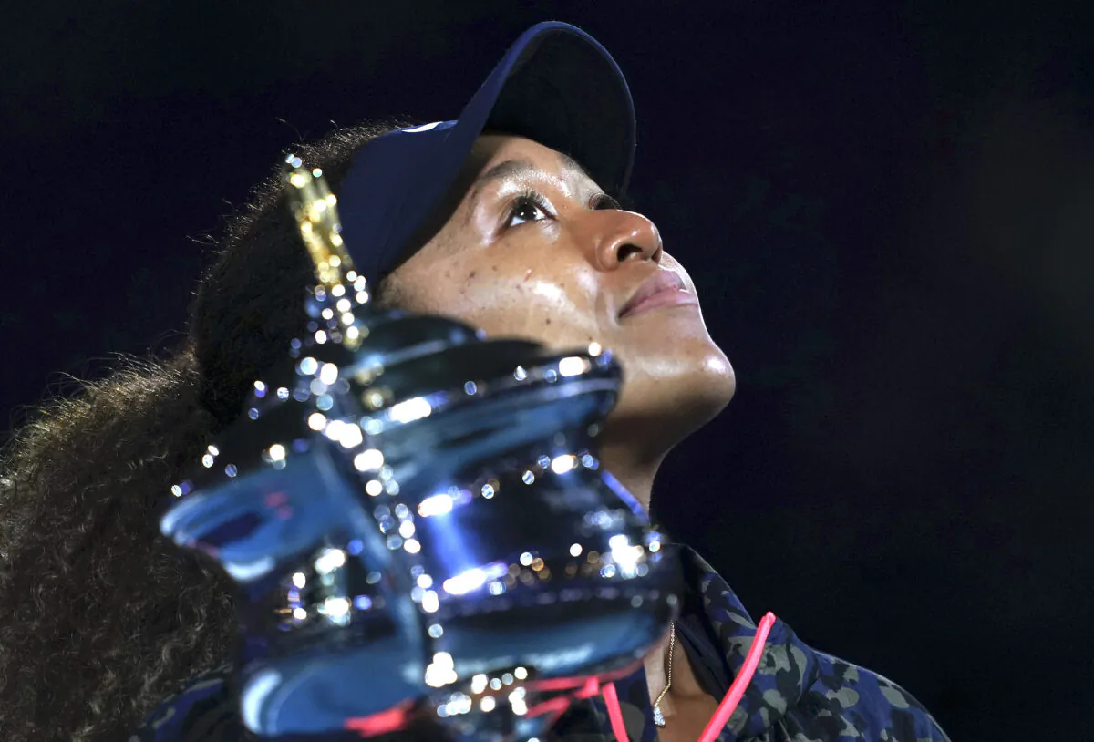 Japan’s Naomi Osaka holds the Daphne Akhurst Memorial Cup aloft defeating United States Jennifer Brady in the women's singles final at the Australian Open tennis championship in Melbourne, Australia, Saturday, Feb. 20, 2021.(Mark Dadswell/AP)