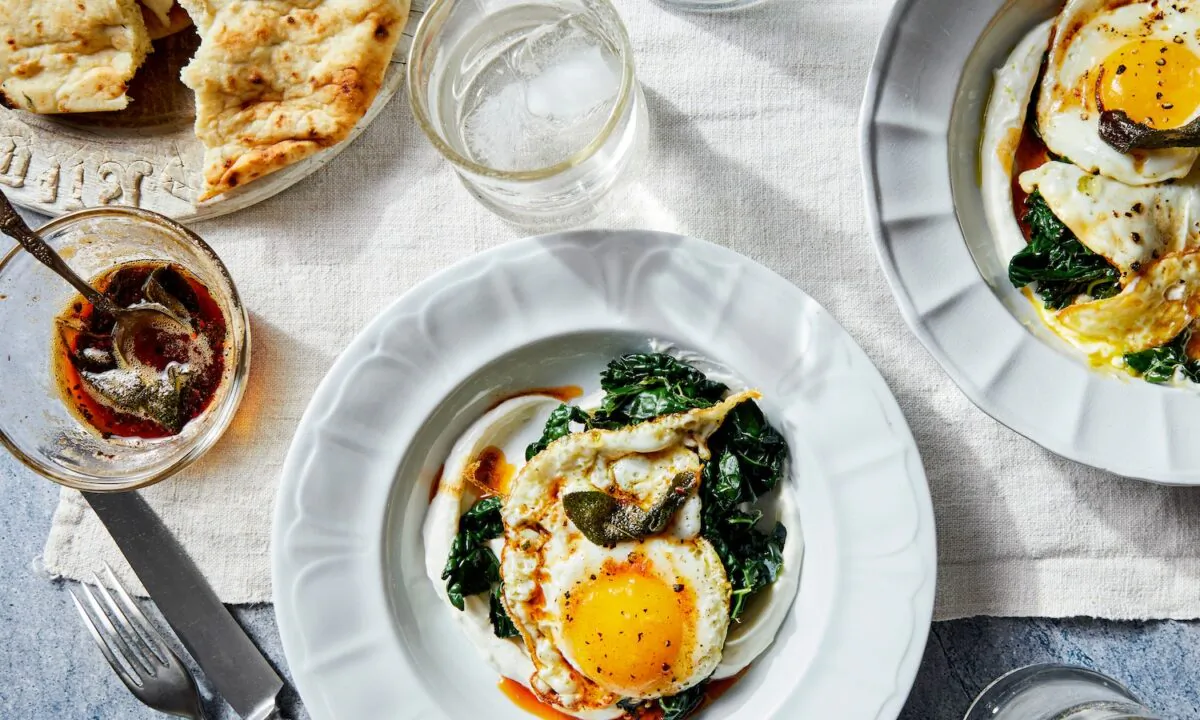 Inspired by a traditional Turkish dish called cilbir, these crispy fried eggs are served over lemony Greek yogurt and garlicky greens, and topped with a drizzle of smoky sage butter. (Kristin Teig/TNS)