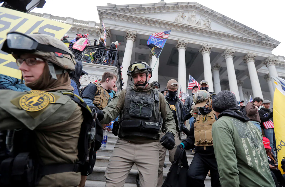 Jessica Marie Watkins (L) and Donovan Ray Crowl (C), both from Ohio, march down the East front steps of the U.S. Capitol with the Oath Keepers group in Washington, Jan. 6, 2021. (Reuters/Jim Bourg)